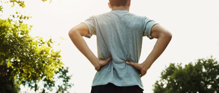Runners back pain after Jogging at the park with sunset